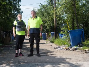Co-founder of Queen City Patrol Patty Will, left, stands with board member Bernie Price, in an alley near the intersection of 3rd Avenue and Cameron Street in Regina, Saskatchewan on July 30, 2020. Queen City Patrol removes drug paraphernalia from Regina streets and the area where the pair is pictured is one where they collect a significant amount of harmful objects.