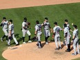 The Miami Marlins celebrate Sunday following their 11-6 victory over the host Philadelphia Phillies. Miami's scheduled Monday home opener against the Baltimore Orioles was postponed due to an outbreak of COVID-19 on the Marlins.