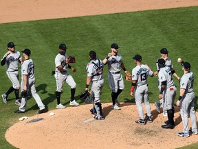 The Miami Marlins celebrate Sunday following their 11-6 victory over the host Philadelphia Phillies. Miami's scheduled Monday home opener against the Baltimore Orioles was postponed due to an outbreak of COVID-19 on the Marlins.