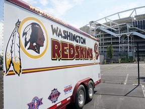 The Washington Redskins team logo is seen on a vehicle parked outside the NFL team's stadium FedEx Field after the team announced it will be abandoning its controversial Redskins team name and logo under pressure from sponsors to scrap the name criticized as racist by Native American rights groups, in Landover, Maryland U.S., July 13, 2020.