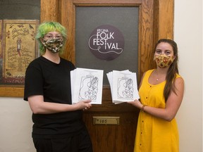 Regina Folk Festival marketing and communications co-ordinator Meghan Trenholm, left, and volunteer coordinator Chloé Golden stand holding pamphlets for this year's altered-format festival in front of the organization's office in Regina on July 29, 2020.