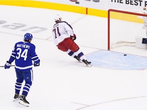 Nick Foligno of the Columbus Blue Jackets scores an empty-net goal against Toronto on Sunday as the Maple Leafs' Auston Matthews looks on in dejection.
