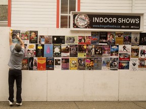 Edmonton Fringe Festival artistic director Murray Utas puts up play posters prior to the 2018 Fringe Festival.