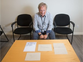 Regina City Clerk Jim Nicol sits with a mock-up of the mail-in ballot election package that will be sent to residents for the upcoming municipal election.