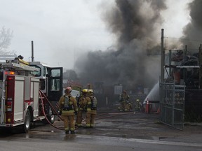 Firefighters work to extinguish a fire at CMS Metal Products near the intersection of 8th Avenue and Winnipeg Street in Regina, Saskatchewan on August 27, 2020.
