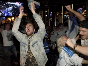 Finnish ice hockey fans drink and celebrate during the IIHF Men's Ice Hockey World Championships final between Canada and Finland at a sports bar in Helsinki, Finland, May 26, 2019.