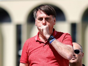 Coughing — as Brazilian President Jair Bolsonaro is pictured doing on April 19, 2020 — is the No. 1 COVID-19 symptom reported by Saskatchewan people.