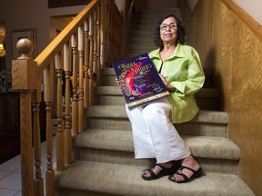 Renu Kapoor displays a poster advertising an India Night event in her Regina home in 2018.