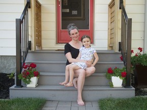 Mackenzie Kulcsár sits with her daughter Mára Kulcsár at their home in Regina, Saskatchewan on July 30, 2020.