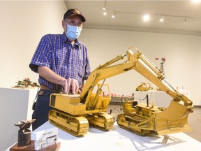 Dick Moulding demonstrated the mechanical trackhoe model he built, which is on display in A Tiny Worlds Fair at the Art Gallery of Regina.