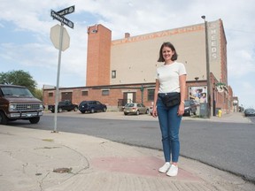 Michelle Harazny, artistic director of Nuit Blanche Regina Art Night stands on the corner of Cornwall Street and Dewdney Avenue in Regina, Saskatchewan on August 26, 2020. Due to COVID-19, this year's instalment of the art show will be a driving tour featuring projections on the walls of buildings.