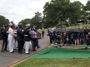 The Honor Guard lowers the casket at the burial service of late U.S. Congressman John Lewis, a pioneer of the civil rights movement and long-time member of the U.S. House of Representatives, in Atlanta on July 30.