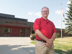 Kurtis Krug, president of the Regina East Zone Youth Soccer Association, stands in front of the W. F. Ready School in Regina, Saskatchewan on August 21, 2020. The organization used to hold soccer games in the school, but has now cancelled their indoor season on account of the COVID-19 pandemic.