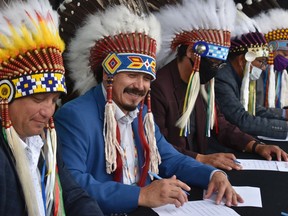 Tribal Council Chief Mark Arcand, far left, next to Whitecap Dakota First Nation Chief Darcy Bear celebrate at Prairieland Park on Sept. 24. Photo taken in Saskatoon, SK on Tuesday, September 24, 2020. (Saskatoon StarPhoenix/Nick Pearce)