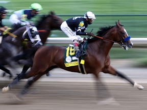 LOUISVILLE, KENTUCKY - SEPTEMBER 05:  Authentic #18 with John Velazquez aboard leads Tiz The Law #16 and the field down the front stretch during the 146th running of the Kentucky Derby at Churchill Downs on September 05, 2020 in Louisville, Kentucky.