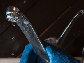 Water drips from a kitchen tap in Regina, Sask.