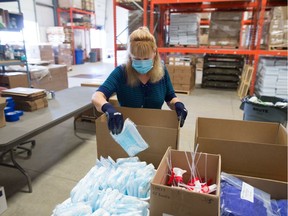 In this file photo from Sept. 4, 2020, election worker Valerie Kuntz packs boxes of PPE to be sent off for use at returning offices and polling stations prior to the provincial election. These supplies were being shipped out from the Elections Saskatchewan warehouse in Regina, Saskatchewan.