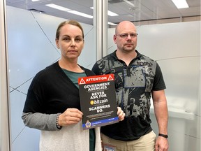 Sergeants Kelley Berting and Bryant Westerman with the Regina Police Service's Commercial Crimes Section with a poster warning the public about bitcoin scams currently impacting people in Regina. HEATHER POLISCHUK/Regina Leader-Post