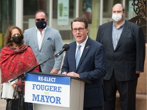 Regina mayor Michael Fougere, at podium, announces the start of the his re-election campaign during an event held on Scarth Street in Regina, Saskatchewan on Sept. 15, 2020.
