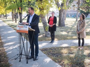 Saskatchewan NDP leader Ryan Meili speaks to media at a news conference held in front of Balfour Collegiate on College Avenue in Regina, Saskatchewan on Sept. 21, 2020. At centre is NDP candidate for Regina University Aleana Young and at right is NDP MLA Nicole Sarauer.