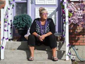 Barb Dedi, former president of the NDP's Regina Walsh Acres riding association, sits on the front step of her home in Regina, Saskatchewan on Sept. 22, 2020.