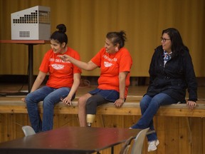 Kerry Benjoe, centre, sits with her daughter Jahnlin Deneyou, left, and cousin Margaret Benjoe in a gymnasium, which is the last remaining building from what was once the Lebret/Qu'Appelle/Whitecalf Industrial School in Lebret, Sask. on Sept. 23, 2020. Both Kerry and Margaret  attended the school as a students.