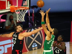 Boston Celtics forward Jayson Tatum (0) shoots against Toronto Raptors centre Marc Gasol (33) and forward Pascal Siakam (43) Wednesday at ESPN Wide World of Sports Complex.