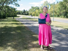 Maria Martinez, who was struck by a cyclist while out walking, stands on the spot the incident occurred on the walking path in Wascana Park in Regina.