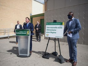Education Minister Gord Wyant, second from frame left, speaks to media at a news conference regarding the opening of a new Francophone elementary school in Regina. The news conference was held at Ecole Du Parc in Regina, Saskatchewan on Sept. 1, 2020.