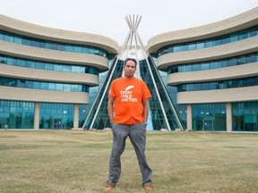 Bradley Bellegarde, cultural diversity & Indigenous relations advisor with Parks, Recreation and Cultural Services for the City of Regina, stands wearing his Orange Shirt Day T-shirt in front of First Nations University in Regina, Saskatchewan on Sept, 29, 2020.