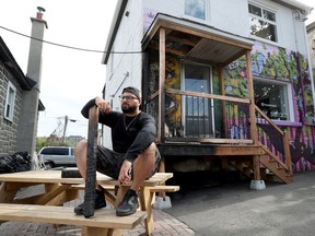 OTTAWA - Hassan (Bongo) Bicher poses for a photo in front of his torched restaurant Super Salads on Preston Street in Ottawa Monday Sept 28, 2020.