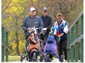 Bob Putz, Ray Bechard, and Gail Putz, from left, walk toward a green at the Tor Hill Golf Course.