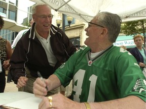 Ron Lancaster, left, and Ron Atchison share a laugh during an autograph session that was part of the 40th-anniversary reunion of the Saskatchewan Roughriders' 1966 Grey Cup-winning team.