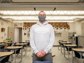 Grade 8 teacher Brett Matlock stands in his classroom in St. Gregory School in Regina, Saskatchewan on Sept. 1, 2020. Students will soon be returning to classrooms and Matlock is among those who will need to follow new safety guidelines as school resumes during the COVID-19 pandemic.