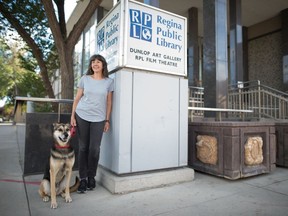 Author J. Jill Robinson stands with her dog Ringo in front of the Regina Public Library's Central Branch in Regina, Saskatchewan on Sept. 4, 2020. Robinson is the library's new writer in residence for 2020-2021.