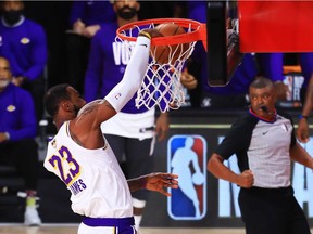 LeBron James of the Los Angeles Lakers dunks against the Miami Heat in Sunday's Game 6 of the NBA championship series.