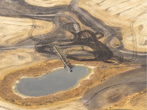 A trench cuts into a wetland in order to drain it, and prepare it for agricultural production in October 2017. The dark areas used to be wetlands. MICHAEL BELL / Regina Leader-Post.