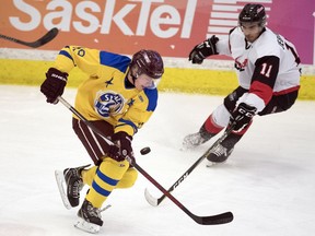 Chase Haygarth, left, tries to skate past John Jebamani during the SJHL-MJHL Showcase tournament held at Co-operators Centre in Regina on Jan. 21, 2020.