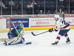 The Regina Pats' Logan Nijhoff,  left, tries to put the puck past Swift Current Broncos goalie Isaac Poulter on Feb. 8 at the Brandt Centre.