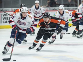 The Regina Pats' Carson Denomie, left, shown being pursued by the Medicine Hat Tigers' Cole Sillinger, is looking forward to playing in the WHL as a 20-year-old now that a Jan. 8 date has been set for the start of the regular season.