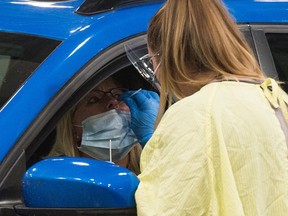 REGINA, SASK : September 8, 2020  -- A health worker demonstrates how a COVID-19 swab test would be conducted at the Saskatchewan Health Authority drive-thru COVID-19 testing facility in Regina, Saskatchewan on Sept. 8, 2020. BRANDON HARDER/ Regina Leader-Post