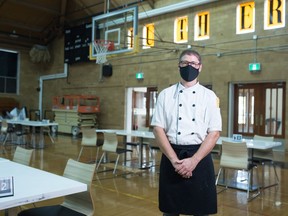 Mike Stobbs, food service manager for Luther College High School, stands in the school's Merlis Belsher Heritage Centre. The historic gymnasium has been turned into a cafeteria due to COVID-19.