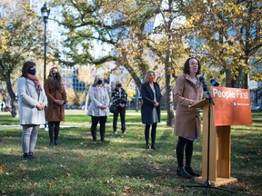 Saskatchewan NDP leader and MLA Nicole Sarauer, right., speaks to members of the media about women's equality during a news conference held in Victoria Park in Regina, Saskatchewan on Oct. 3, 2020. Behind her are a collection of NDP candidates and supporters.