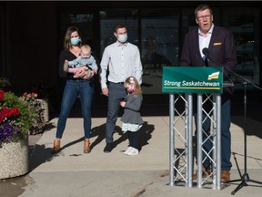 Scott Moe speaks to media about improving supports for those with diabetes during a news conference held at a Saskatchewan Party campaign office in Regina, Saskatchewan on October 7, 2020. Behind Moe are Dustin, centre, and Aly Halvorson, left, with children Brodie, held by Aly, and Hartley, standing. Hartley has diabetes, for which she needs an insulin pump.