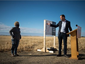 Saskatchewan NDP Leader and MLA Ryan Meili, right, speaks to media about health care wait times during a news conference near Saskatchewan Polytechnic in Regina on Oct. 7, 2020. Behind Meili is Donna Smith, a woman who is concerned about wait times.