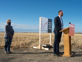 Saskatchewan NDP leader and MLA Ryan Meili, right, speaks to media about health care wait times during a news conference near Saskatchewan Polytechnic in Regina, Saskatchewan on October 7, 2020. Behind Meili is Donna Smith, a woman who is concerned about wait times.