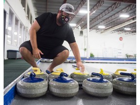 AJ Scott, general manager of the Highland Curling Club, recently demonstrated the wiping down of a rock at the club on Broad Street.