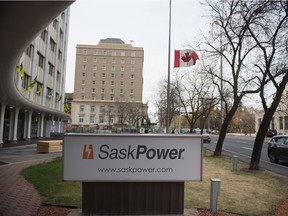 A flag flies at half mast in front of the SaskPower building in downtown Regina, Saskatchewan on Oct. 9, 2020.