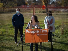 Saskatchewan NDP MLA Nicole Sarauer, centre, speaks during a news conference held on the edge of Wascana Park in Regina, Saskatchewan on Oct. 10, 2020. Trent Wotherspoon, left, and Carla Beck, right, both NDP MLAs, are also pictured.