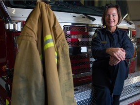 Angela Prawzick, first public education officer with Regina Fire & Protective Services sits on one of the trucks at a fire hall on Dewdney Avenue in Regina, Saskatchewan on Oct. 14, 2020.